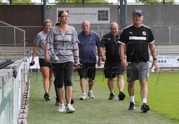 20 July 2023. Dartford manager Alan Dowson walks 140 circuits of the Bericote Powerhouse Princes Park Stadium (equivalent to a marathon distance) to raise funds.